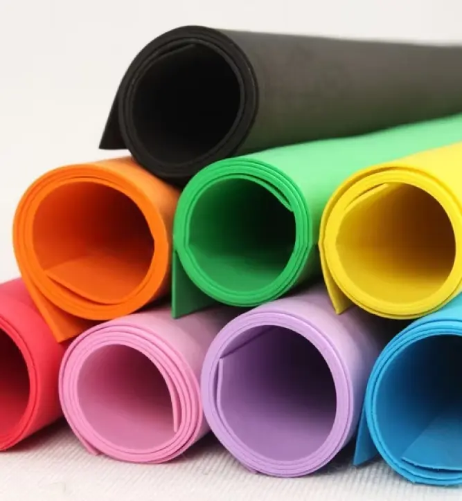 Stacked rolls of EVA foam sheets in various colors including black, green, yellow, orange, pink, purple, and blue